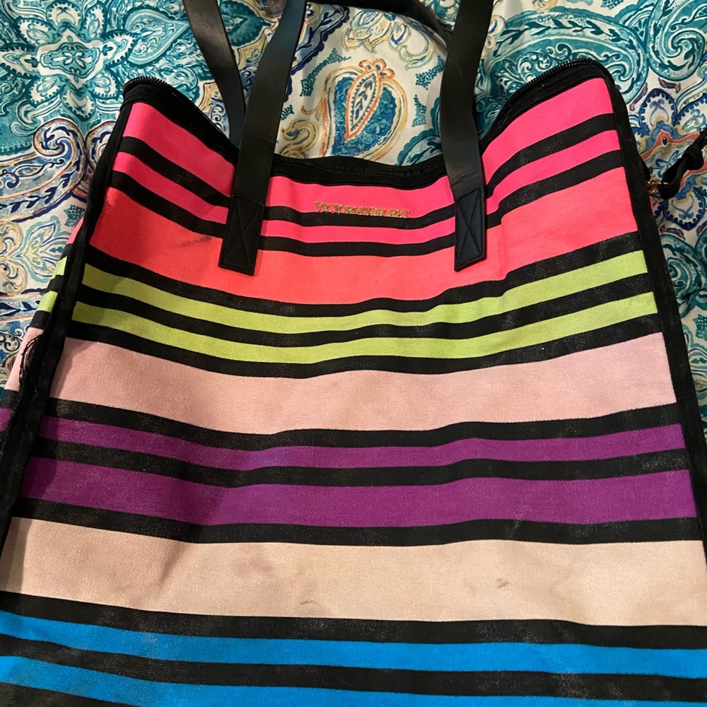 Bag is worn has some stains and signs of fading .